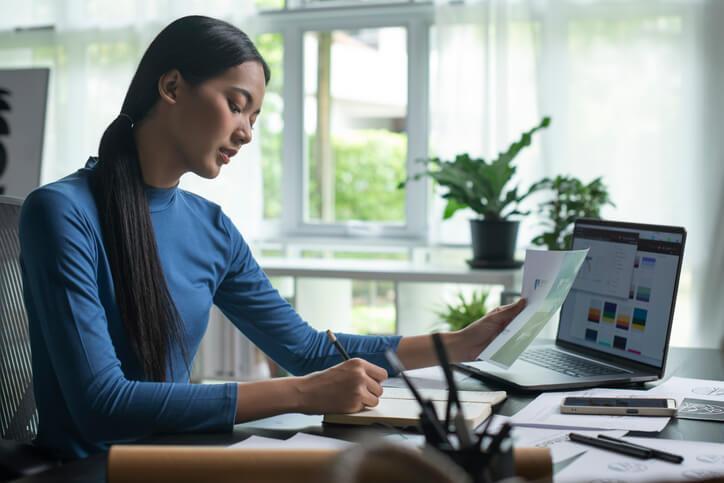 A career training program grad working at a desk in a home office.