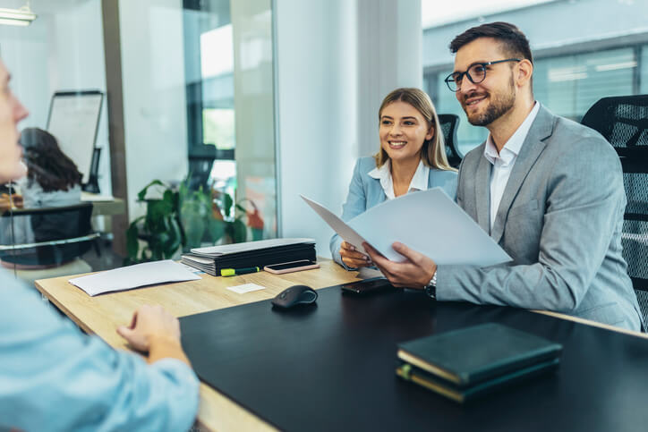 A pair of human resources administration training program grads interviewing a candidate